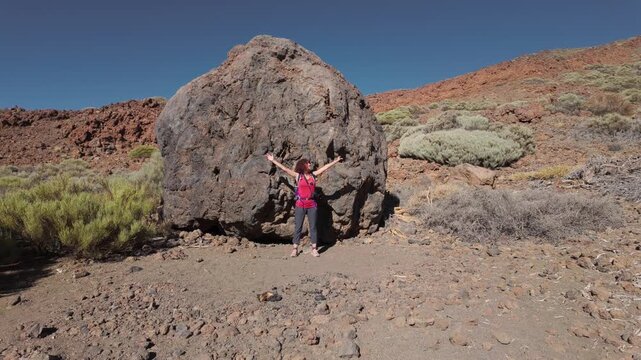 Woman posing by lava ball