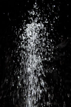 Water splashes in a dark setting during nighttime, creating a dynamic visual effect