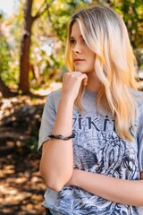 Fototapeta premium Close up portrait of young woman in casual outfit looking away outdoors