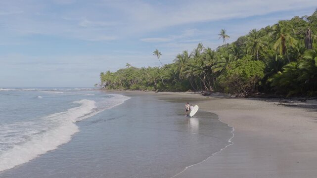 Surfer Girl on a Tropical Costa Rican Beach at Late Afternoon