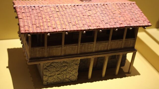 A model of a single-family home with a bright red roof, ideal for architecture or design concepts