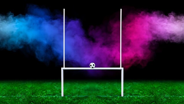 Soccer ball resting on white rugby goal posts with dramatic blue and pink smoke clouds on green grass at night, football