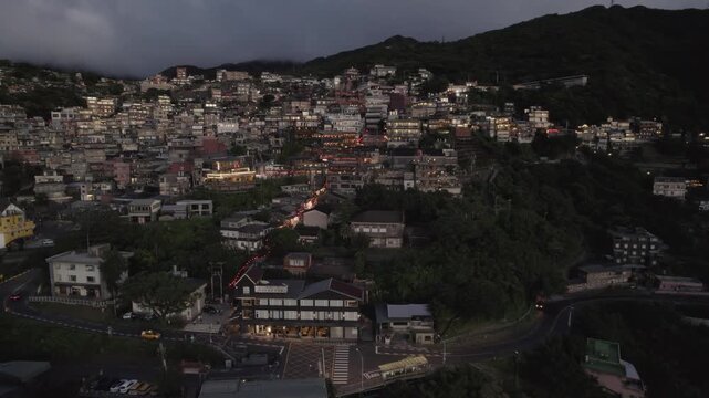 Taiwan, Jiufen town in the evening, Aerial drone of old town Jiufen, famous landmark tourist village on the mountain in Taiwan full of houses on a steep hill and a famous street full of lanterns.