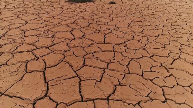 Climate change or global warming - flight over cracked dry sludge in a dried up pond 04