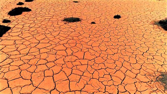 Climate change or global warming - flight over cracked dry sludge in a dried up pond  05