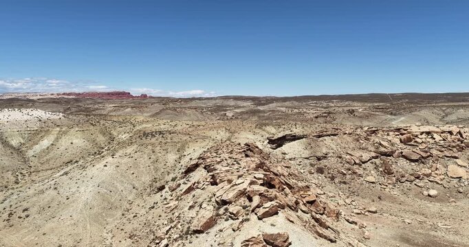 Aerial of Moab Utah BLM land desert terrain with rocks and rolling hills in springtime