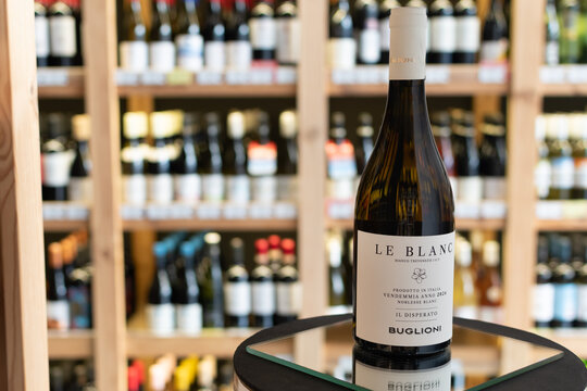 Bottle of Buglioni Le Blanc Il Disperato Bianco Trevenezie IGT white wine on a mirror surface in a wine store with blurred shelves in the background. Ukraine, Zhytomyr, April 28, 2026
