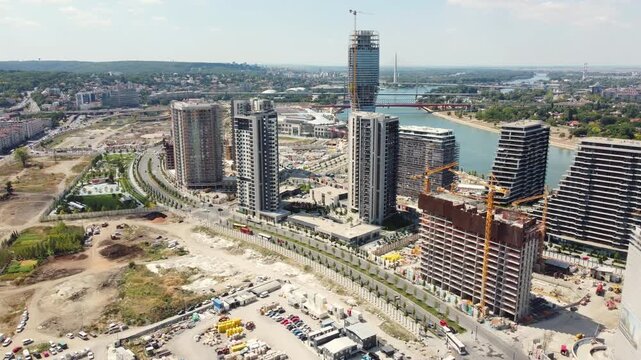 Modern riverside development in Belgrade, Serbia: aerial reveal shot on a sunny day.