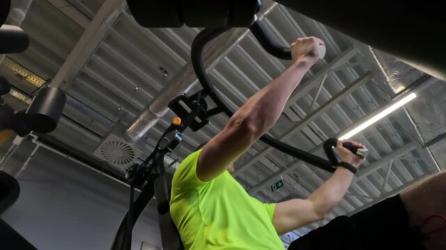 Athletic Man Training Chest Muscles On A Cable Machine In The Gym