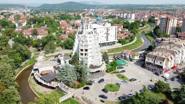 Aerial drone rotation revealing Paracin town center and Crnica river ona a sunny day, central Serbia.