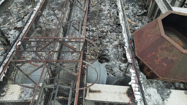 Close-up drone sideways flight over rusted metal roof skeleton, industrial decay, socialist ruins.