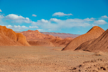 Obraz premium Martian landscape in the Devil's Desert near Tolar Grande, Salta, Argentina. Arid red clay hills and road in the Puna de Atacama wilderness.