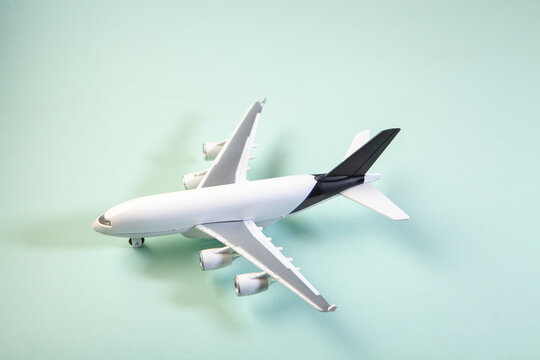 Model of airplane on a green background. Travel and business concept.