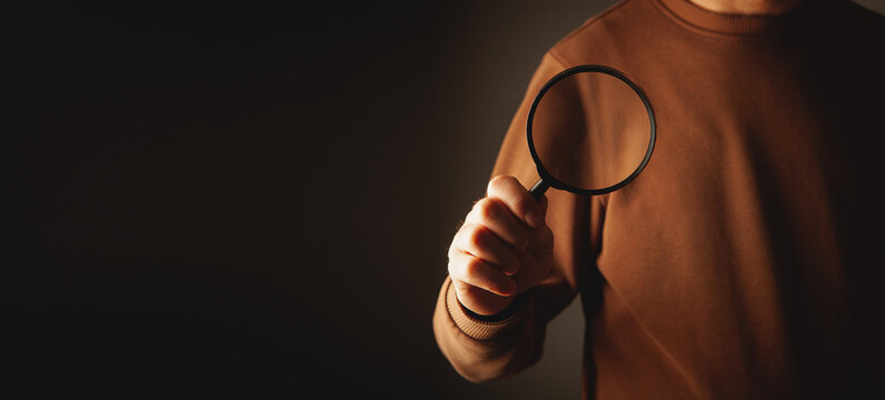 magnifier in man 's hand. magnifier with a magnifying glass in the hands
