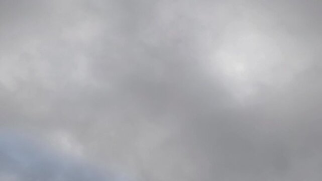 Grey stratocumulus clouds moving at dawn