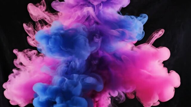 Colored smoke clouds rise and swirl against a dark background in shades of pink and blue