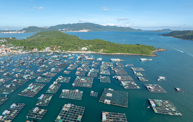 A vast array of floating fish farms in Hon Mieu, Nha Trang, Vietnam, showcases the region's aquaculture industry and its vital role in the local economy. © Zenstratus