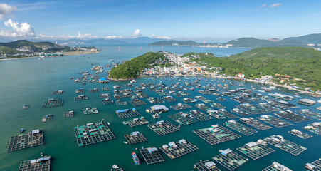 A vast array of floating fish farms in Hon Mieu, Nha Trang, Vietnam, showcases the region's aquaculture industry and its vital role in the local economy. © Zenstratus
