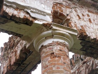 historic building ruins, a crumbling cylindrical brick column reveals intricate, weathered details © Industrial Supplier