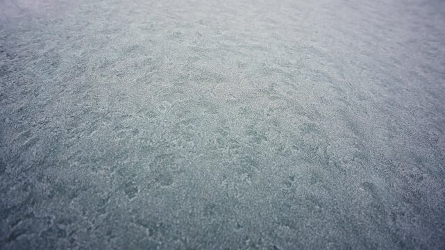 Dangerous expedition walk over frozen river or lake with thin ice layer of frozen water