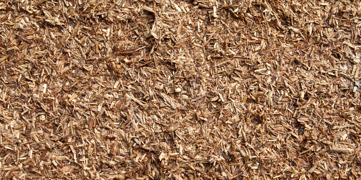 The rough, natural surface texture of wood chips or wood mulch
