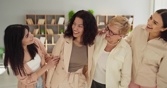 Women team celebration support friendship unity success. Smiling colleagues in a bright office show happiness, togetherness, diversity and inclusion. Clear concept of teamwork and unity.