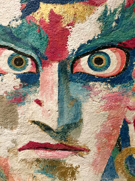 Ancient Buddhist Temple Mural Depicting a Fierce Dharma Protector with Intense Gaze and Vibrant Traditional Colors