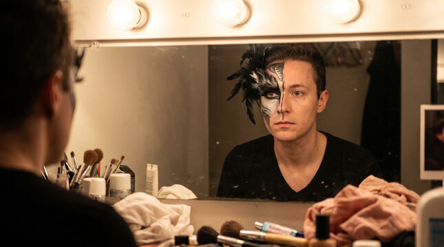 Actor With Half Face Makeup Looking In Mirror