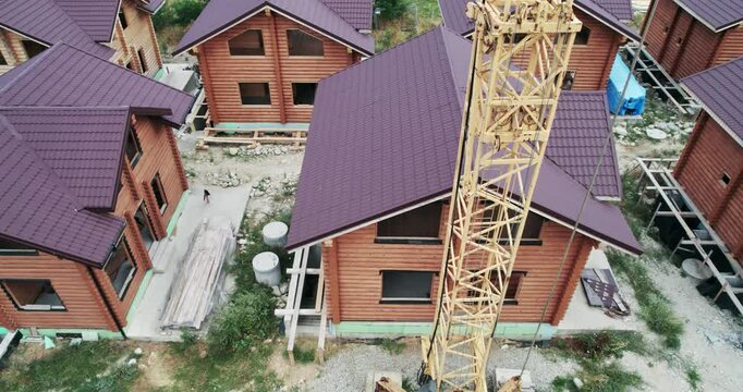 Drying and assembly of wooden log house at a construction base, industrial backgorund, aerial view