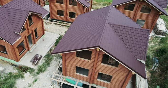 Wooden mountain house construction site, aerial view