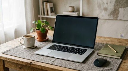 Fototapeta premium Laptop on a desk with coffee and plant
