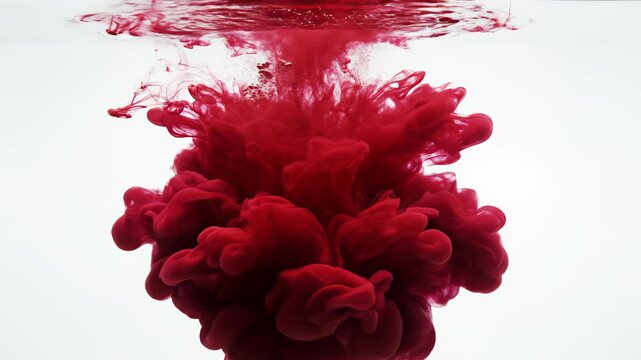 Red ink dispersing in water emphasizing modern aesthetics and minimalist design