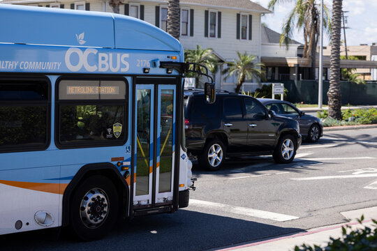 Buena Park, California, USA - April 11, 2026: An OC Bus, powered by natural gas, passes northbound on Beach Blouelvard to the Metrolink Station.