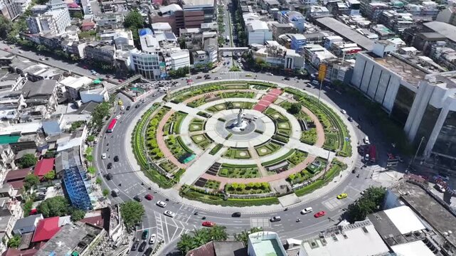 Timelapse of traffic around Wongwian Yai roundabout, King Taksin monument. Circular motion creates continuous flow pattern.