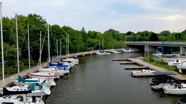 Sailboats docked along Bronte Harbour canal with bridge in Oakville.mp4