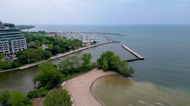 Aerial view of Bronte Beach shoreline and marina entrance in Oakville.mp4