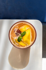 Top Down View of Iced Peach Mango Tea with Mint Garnish © Dimitar