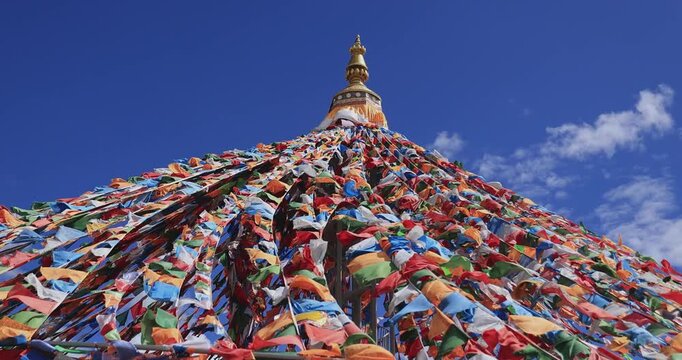 The Changqing Chunker Temple  in Litang, China. Many colourful prayer flags on the mountain top beside the temple.Spirituality and meditation.