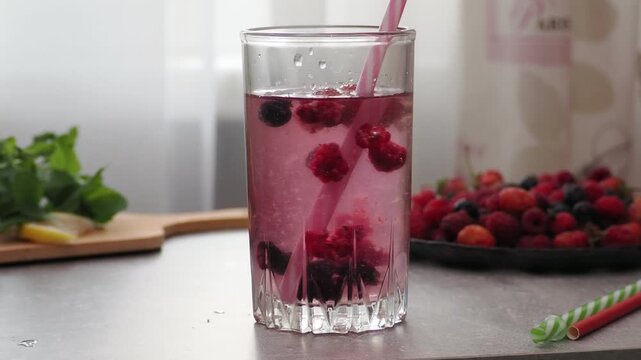 Summer drinks, colored cocktails on table. Lemonade, mojito, strawberry lemonade, tonic water. A refreshing summer drink with raspberries and blueberries, a detox drink for weight loss and keeping fit