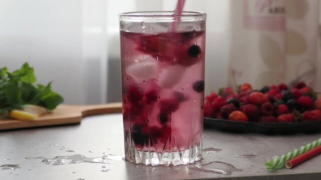 Summer drinks, colored cocktails on table. Lemonade, mojito, strawberry lemonade, tonic water. A refreshing summer drink with raspberries and blueberries, a detox drink for weight loss and keeping fit