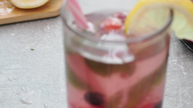 Summer drinks, colored cocktails on table. Lemonade, mojito, strawberry lemonade, tonic water. A refreshing summer drink with raspberries and blueberries, a detox drink for weight loss and keeping fit