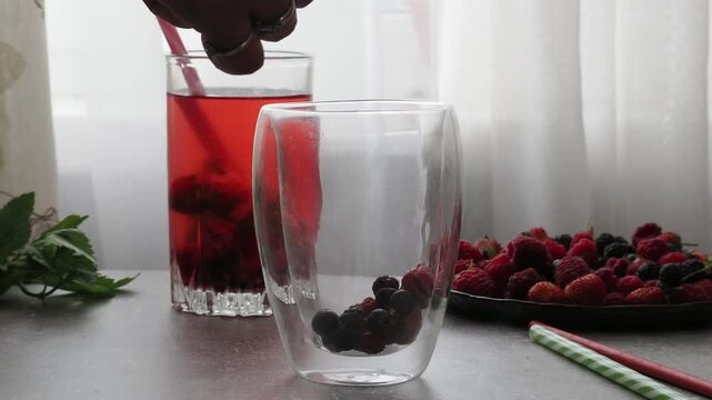 Summer drinks, colored cocktails on table. Lemonade, mojito, strawberry lemonade, tonic water. A refreshing summer drink with raspberries and blueberries, a detox drink for weight loss and keeping fit