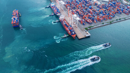 Obraz premium multiple tugboats assisting and maneuvering large container ships in a busy industrial harbor. Concept of maritime logistics coordination, international trade, and efficient port terminal operations.