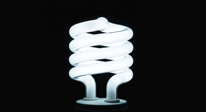 A brightly glowing spiral compact fluorescent light bulb stands out against a stark black background, symbolizing energy efficiency and innovation.