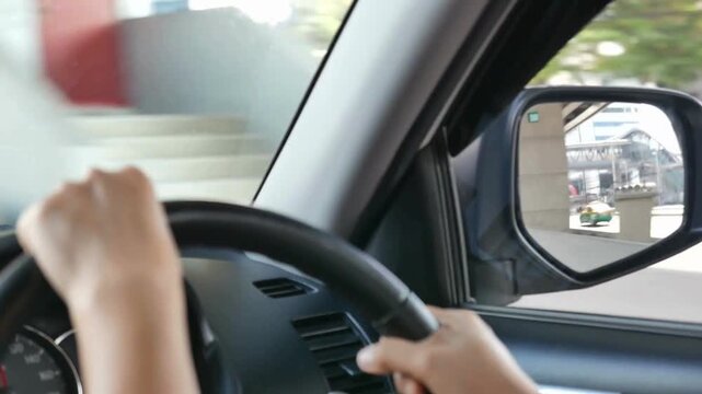 Male hand hold a steering wheel confidently. Driving vehicles. Man driving his car. Safety and attention on the road. Close up view of man keeping hand on the steering wheel while driving a car.
