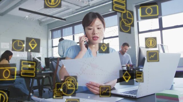 Woman reading reports in business office speaking on call, causing yellow icons clarifying figures
