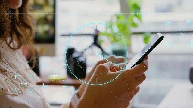 Female creator holding smartphone at desk, thumbs tapping, HUD rotating and growing, demoing AR UI