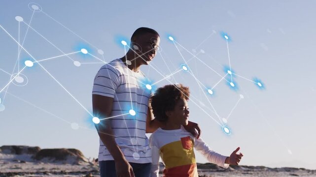 Dad holding child walking on beach, child pointing to horizon causing tech nodes forming over them