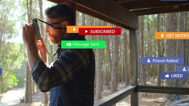 Man adjusting camera on deck, social media alerts drifting, gathering, receding, framing trees shot