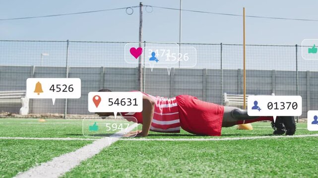 Man starting high plank and doing pushups on turf while training with icons popping over torso